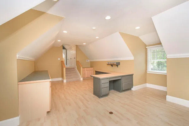 an empty room with a window and a ceiling fan
