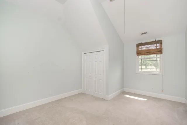 an aerial view of a house with a garden and lake view