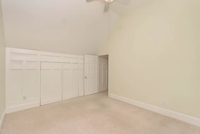 a front view of a house with a garden and yard