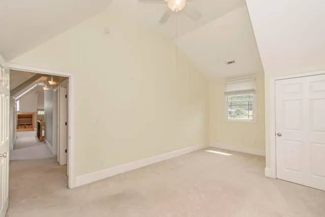 a view of a field with trees in the background