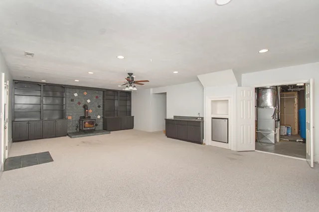 a front view of a house with a yard deck and trees