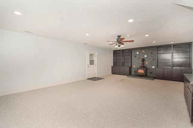 front view of a house with a yard and potted plants