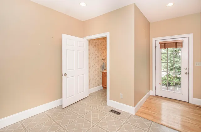 a kitchen with stainless steel appliances granite countertop a sink a stove a refrigerator and a wooden floor