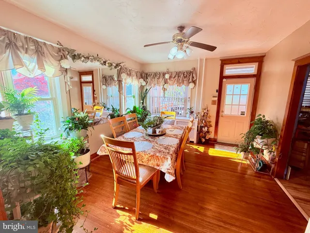 a dining room with furniture a potted plant and a chandelier