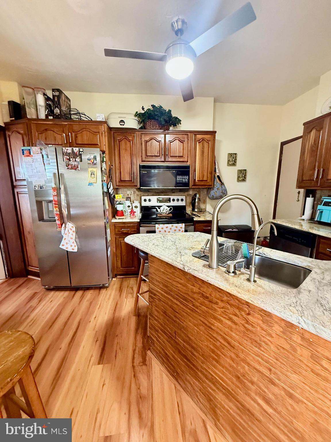 1200 Hampden Boulevard Reading, PA 19604 - Photo 13 of 32 a kitchen with stainless steel appliances granite countertop a sink stove and wooden cabinets