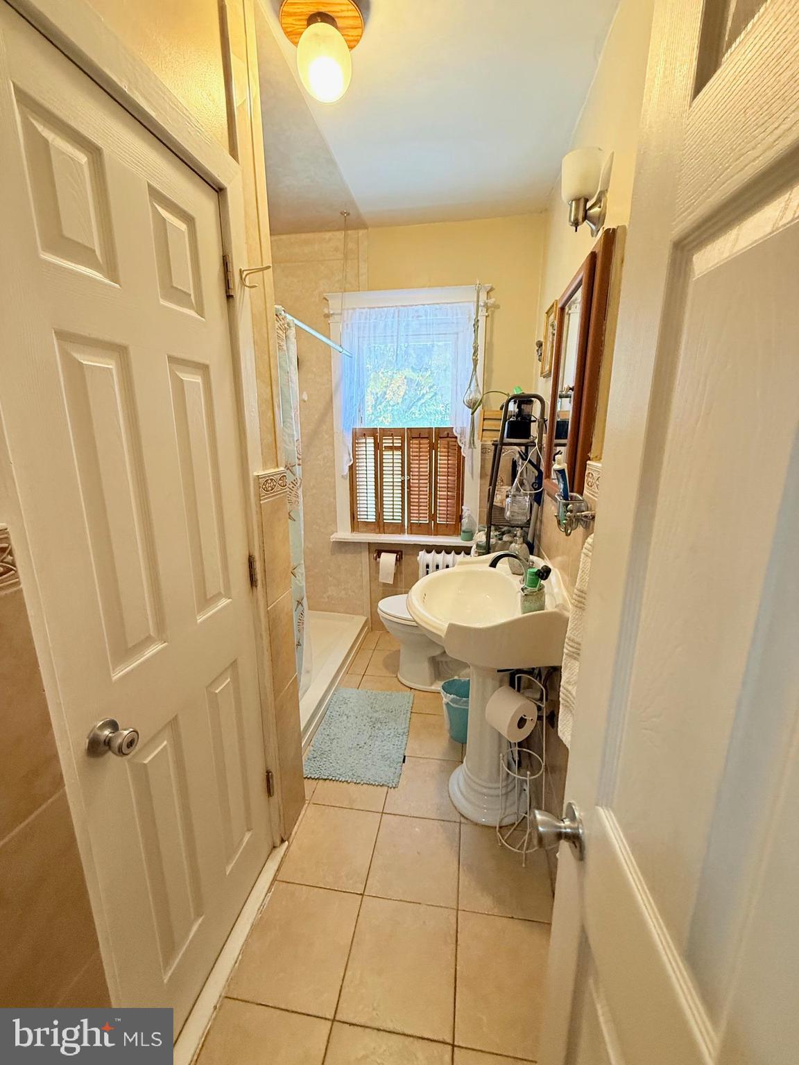 1200 Hampden Boulevard Reading, PA 19604 - Photo 20 of 32 a bathroom with a sink a mirror and a shower