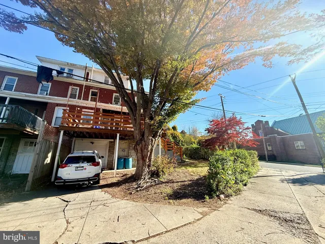a car parked in front of a brick house