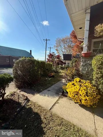 a car parked in front of a brick house