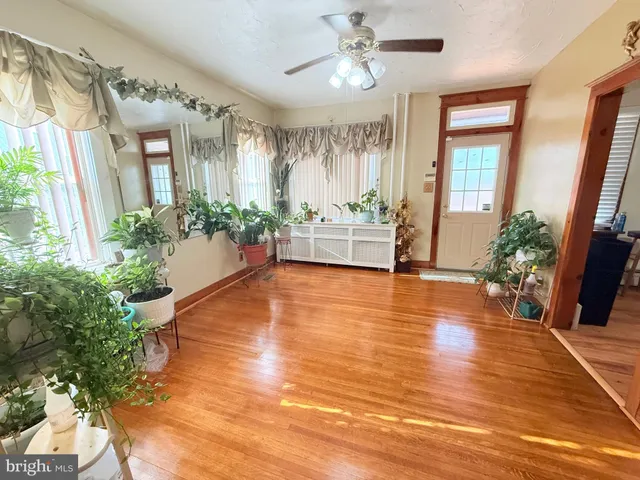 a view of an room with wooden floor and windows
