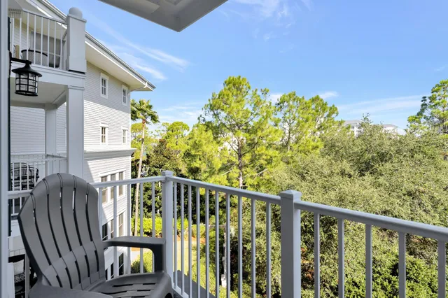 a view of a chairs and table in the balcony