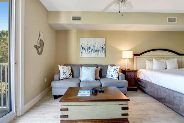 a bedroom with a bed and a painting on the wall