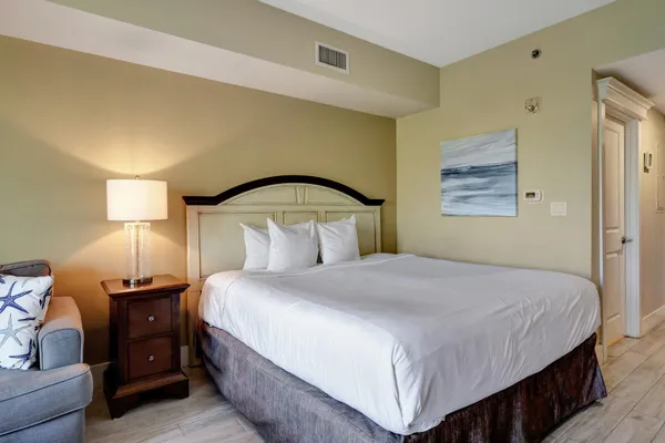 a bedroom with a bed and lamp