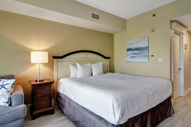 a bedroom with a bed and lamp