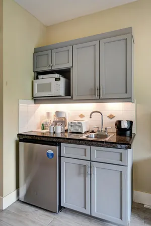 a kitchen with granite countertop a sink and cabinets