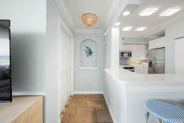 a kitchen with a sink a counter top space and stainless steel appliances