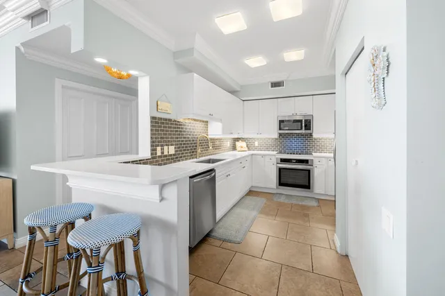 a kitchen with a refrigerator stove and oven
