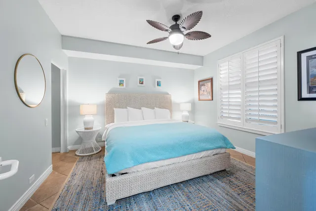 a bedroom with a bed and a flat tv screen on dresser