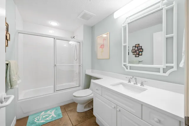 a bathroom with a sink mirror and vanity
