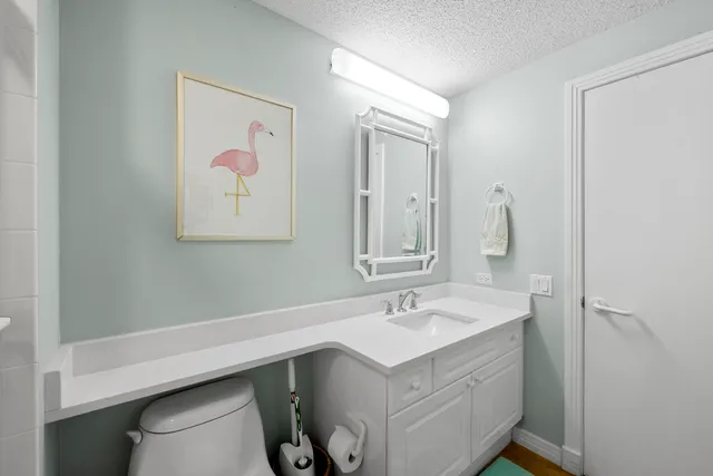 a bedroom with a large bed and a flat tv screen on dresser