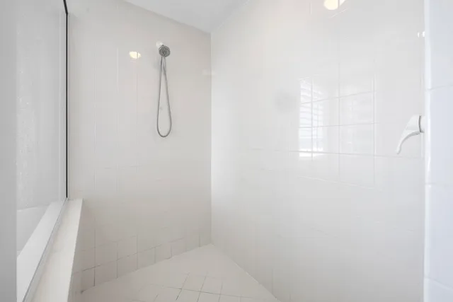 a spacious bathroom with a granite countertop toilet sink and mirror
