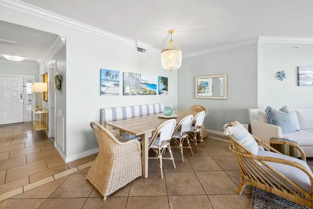 a dining room with wooden floor and chandelier