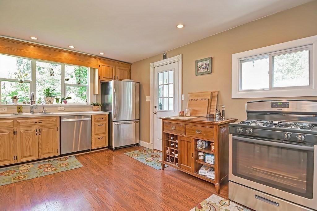 158 Union Street Randolph, MA 02368 - Photo 13 of 41 a kitchen with stainless steel appliances a stove a sink and a refrigerator