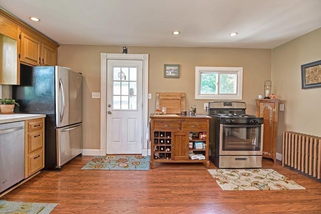 158 Union Street Randolph, MA 02368 - Photo 15 of 41 a kitchen with stainless steel appliances granite countertop a refrigerator stove top oven and sink