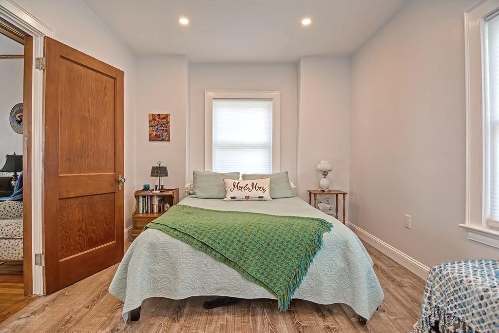 158 Union Street Randolph, MA 02368 - Photo 28 of 41 a bedroom with a bed and wooden floor