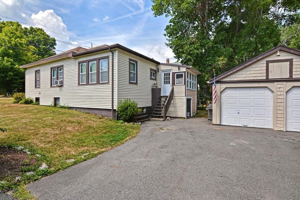 158 Union Street Randolph, MA 02368 - Photo 3 of 41 a front view of house with yard and trees in the background
