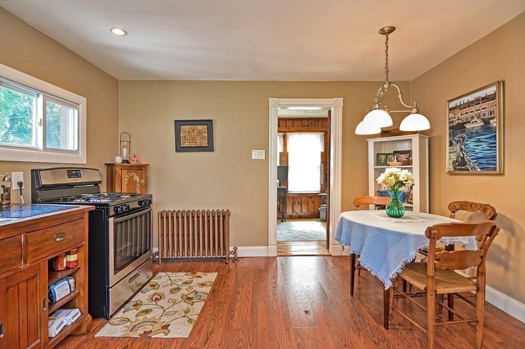 158 Union Street Randolph, MA 02368 - Photo 8 of 41 a dining room with furniture a chandelier and wooden floor