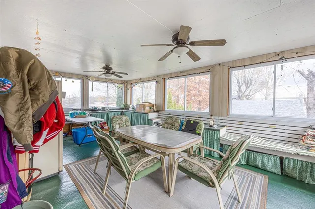 a dining room with furniture a rug and a chandelier