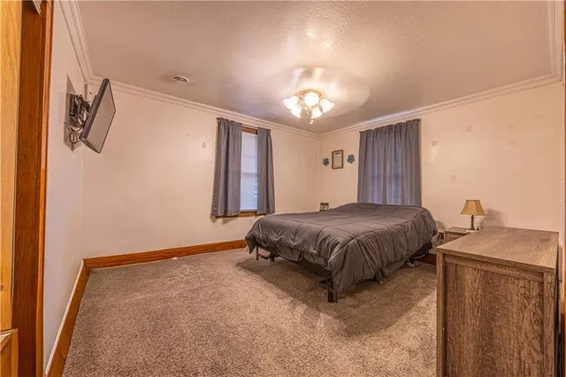 a spacious bedroom with a bed and a chandelier