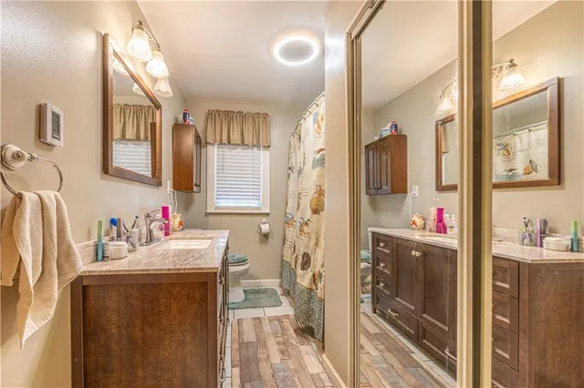 a bathroom with a sink vanity mirror and shower