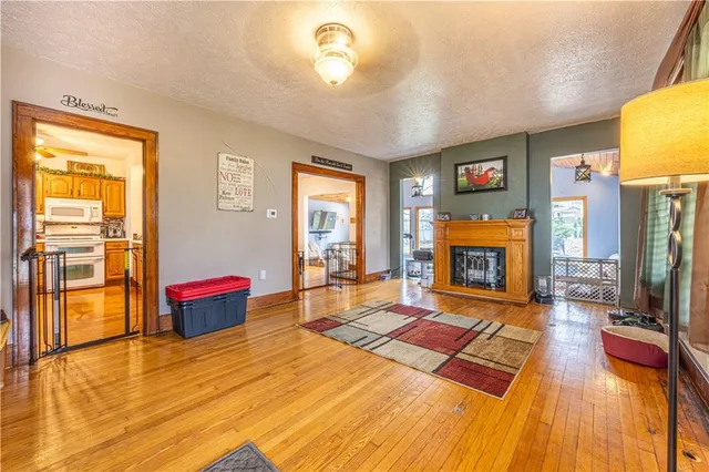 a living room with a fireplace dining table and a fireplace