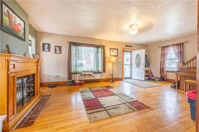 a living room with patio furniture and a fireplace