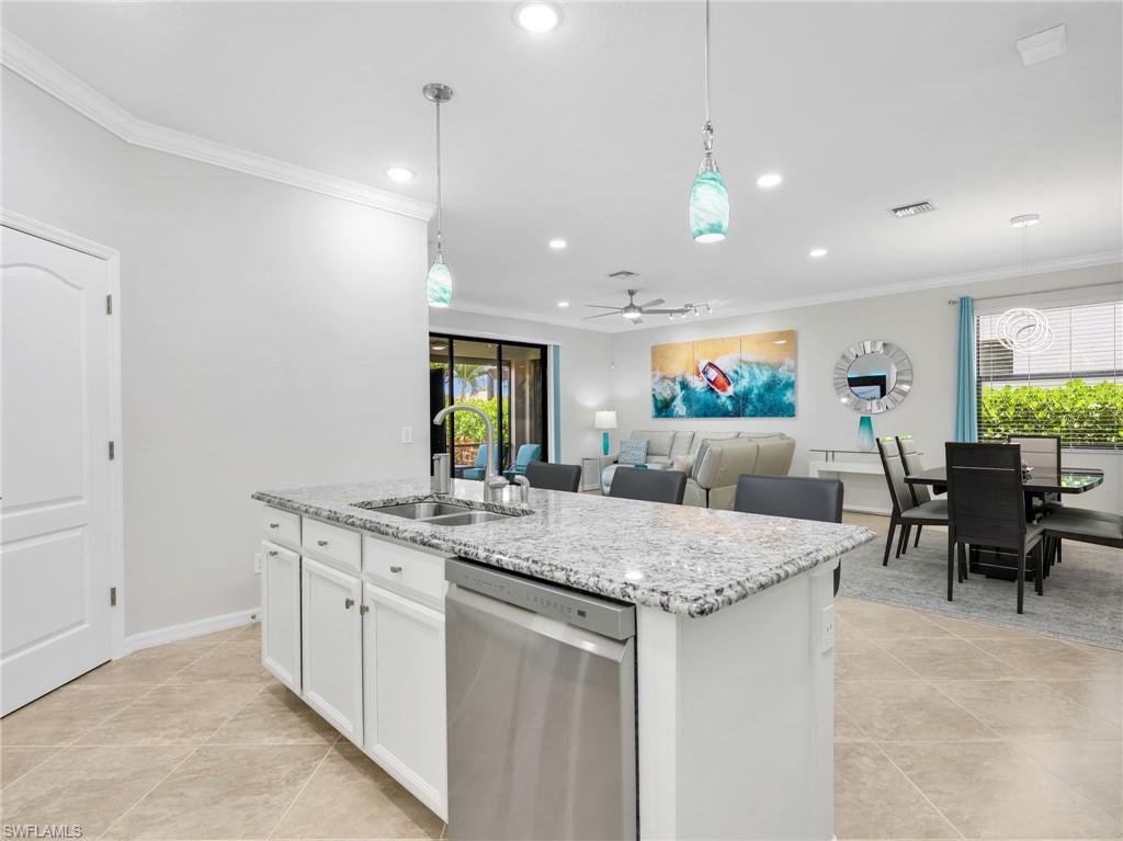 4383 Bismark Way Naples, FL 34119 - Photo 7 of 49 Kitchen Island, Living Room & Dining Room with Sliders with Verticell Shade Leading to Screened In Lanai