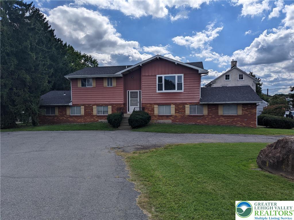 745 Easton Road, Unit 2 Hellertown, PA 18055 - Photo 1 of 12 a front view of a house with a garden and yard