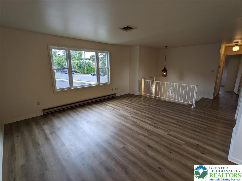 745 Easton Road, Unit 2 Hellertown, PA 18055 - Photo 3 of 12 a view of an empty room with wooden floor and a window