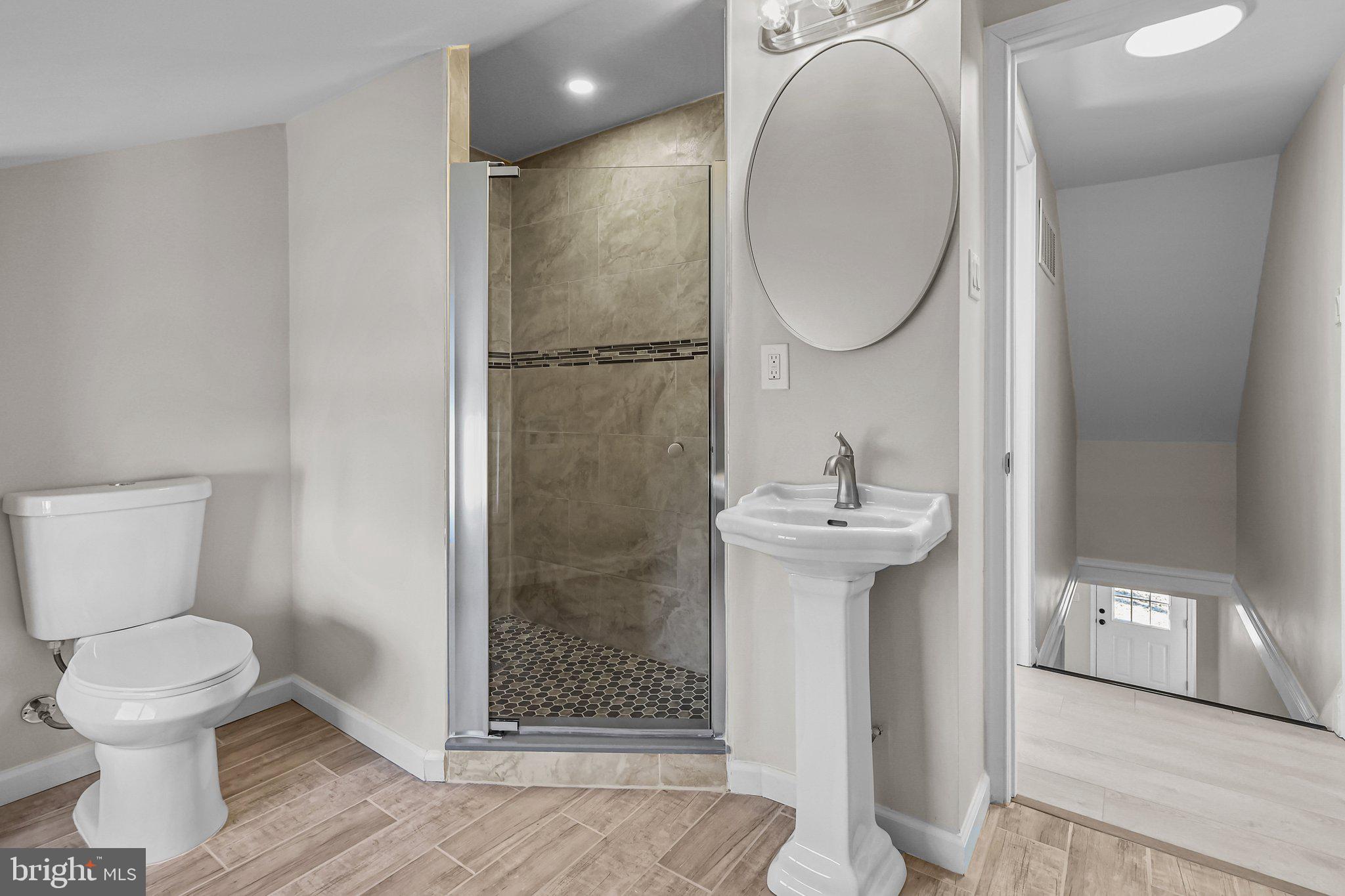 121 Goldengate Road Levittown, PA 19057 - Photo 27 of 32 a bathroom with a sink toilet and a mirror