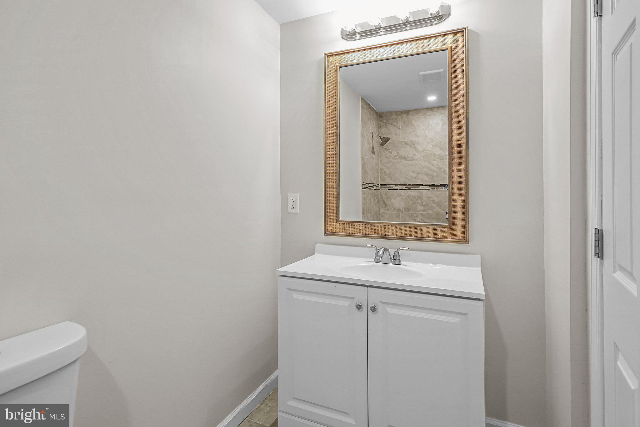 121 Goldengate Road Levittown, PA 19057 - Photo 6 of 32 a bathroom with a sink a toilet and mirror