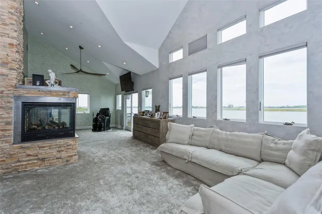 a living room with furniture large window and a fireplace
