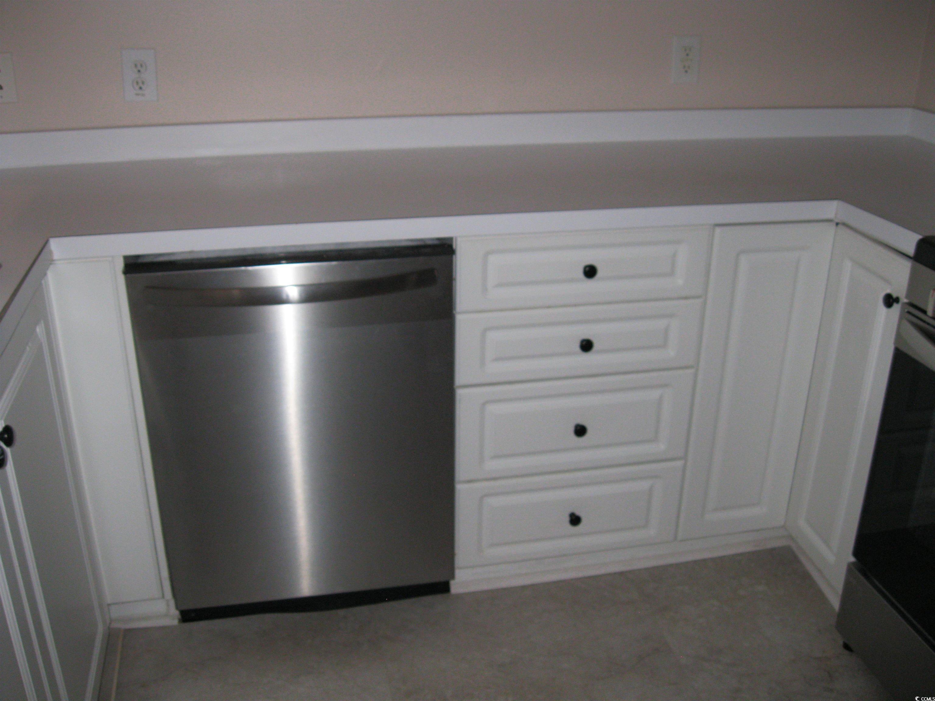 4672 Lightkeepers Way, Unit 50E Little River, SC 29566 - Photo 7 of 19 Kitchen featuring stove, white cabinetry, and stainless steel dishwasher
