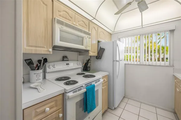 a kitchen with a sink a refrigerator and cabinets