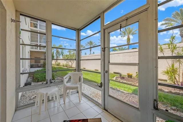 a view of a house with a yard and potted plants