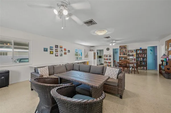 a living room with furniture a flat screen tv and a large window