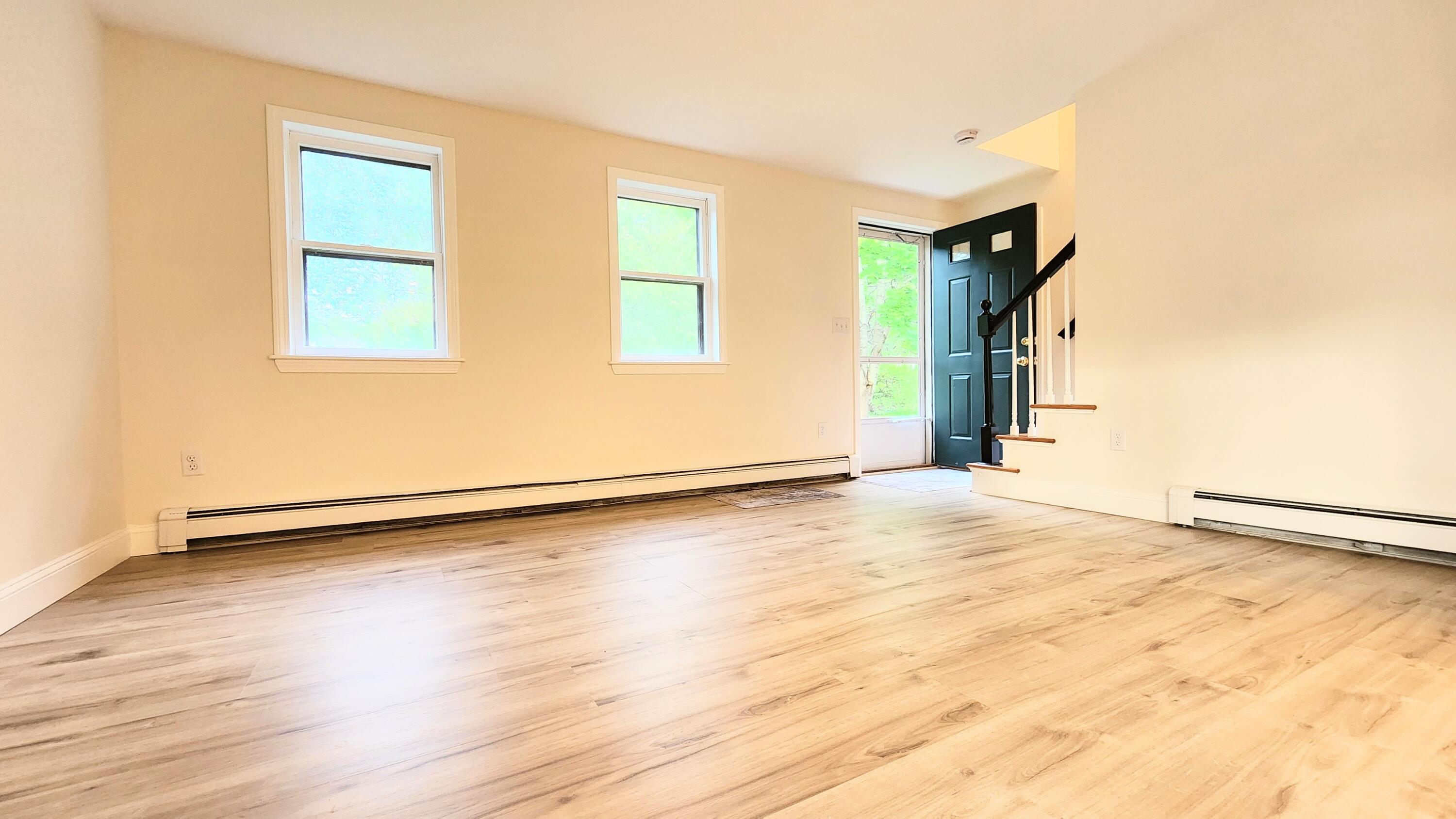 147 Chippingstone Road Marstons Mills, MA 02648 - Photo 10 of 23 an empty room with wooden floor and windows