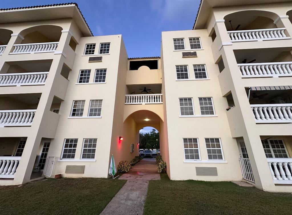 Condominio Sol & Playa Condominio Sol & Playa 113th Rincon, PR 00677 - Photo 1 of 1 a front view of a house with a yard