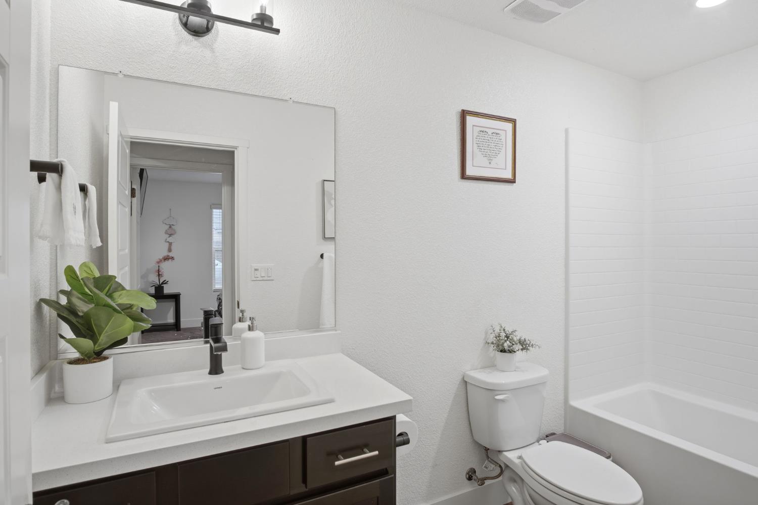 1666 Oak Street Los Banos, CA 93635 - Photo 14 of 34 a bathroom with a sink toilet a mirror and shower
