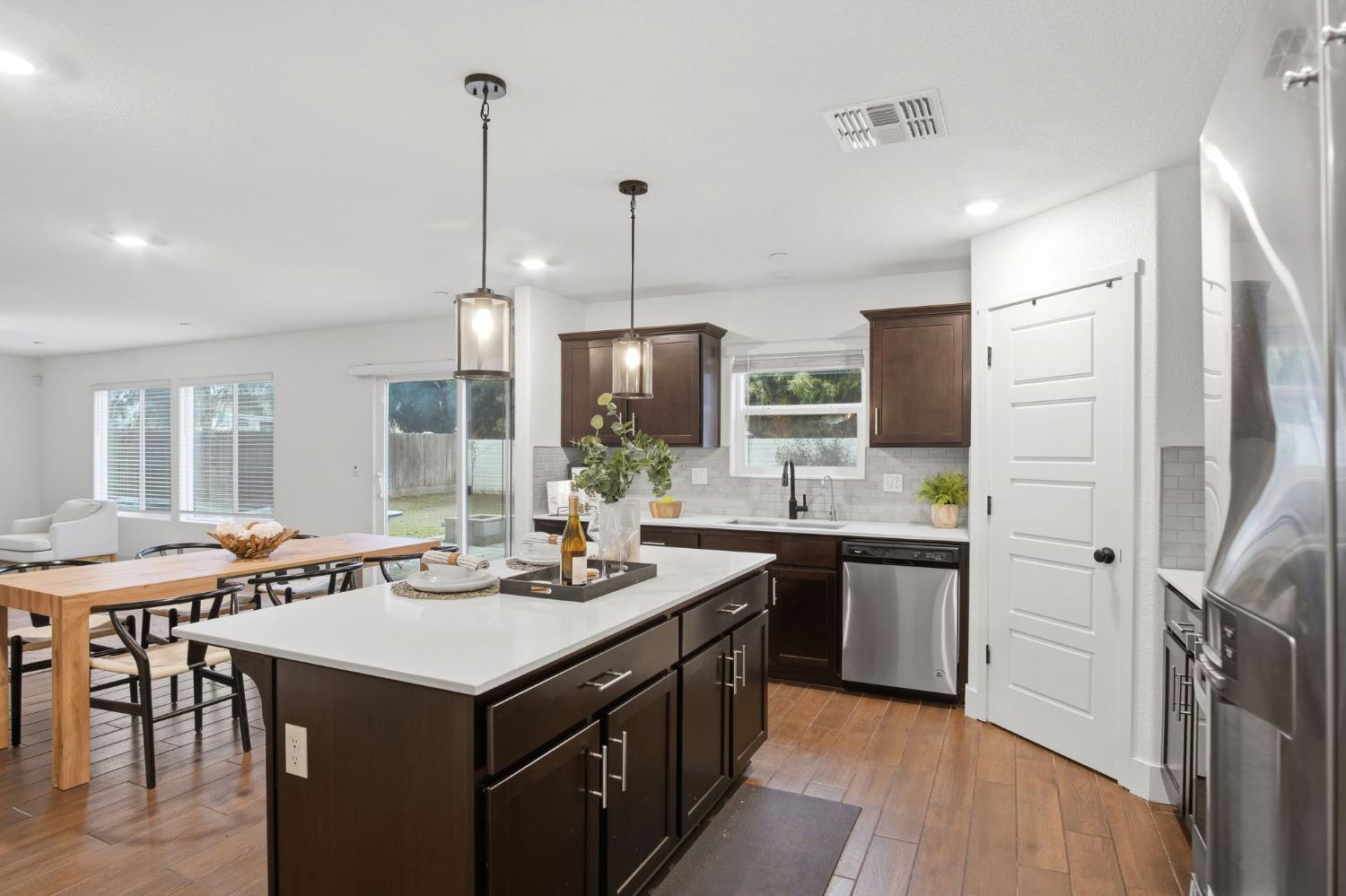 1666 Oak Street Los Banos, CA 93635 - Photo 6 of 34 a kitchen with kitchen island a sink stove and refrigerator