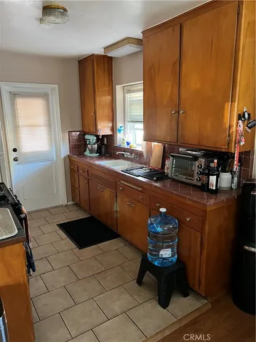 a kitchen with stainless steel appliances a sink stove and cabinets